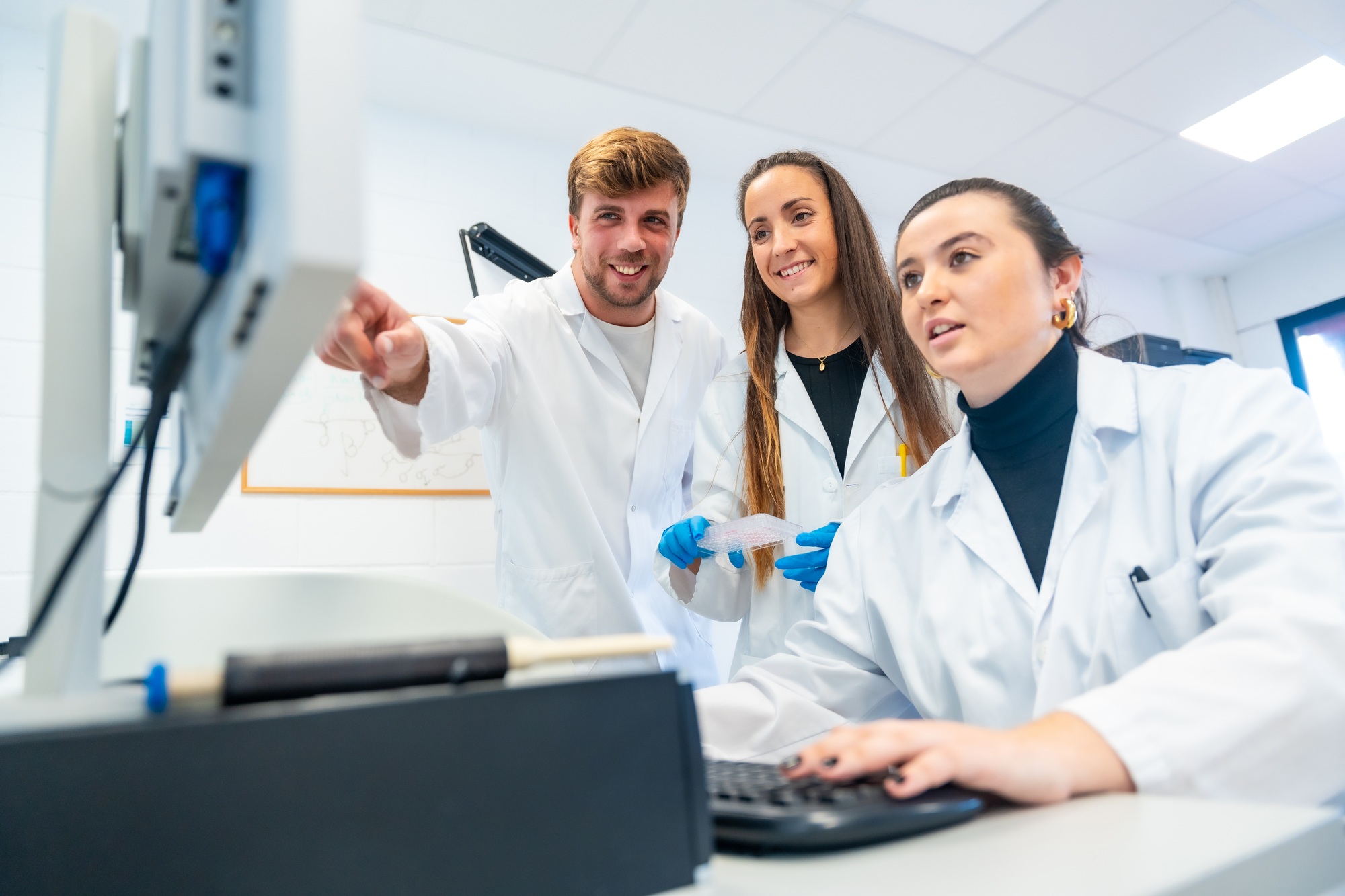 Happy doctors using computer in a research laboratory